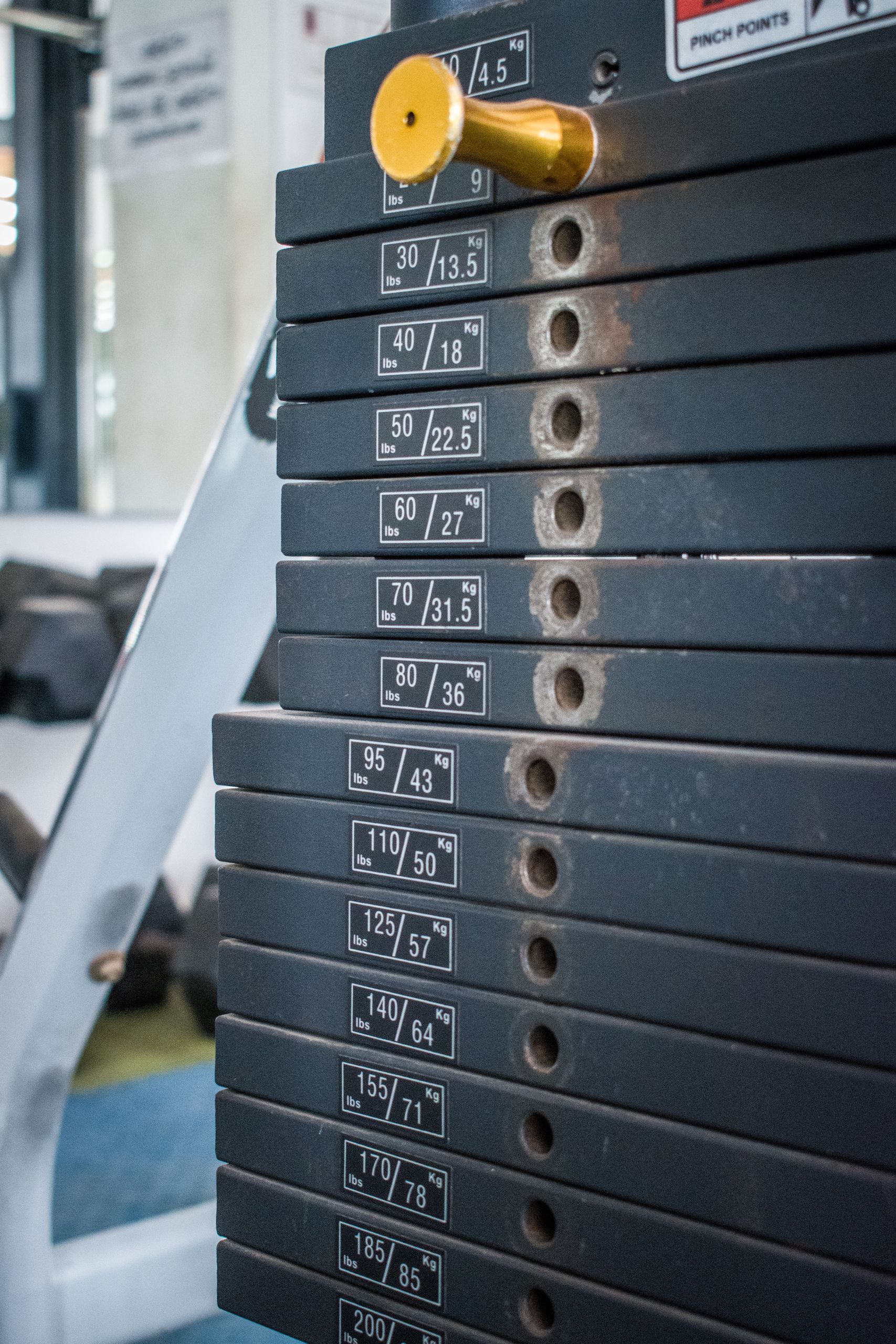 Close-up view of gym weight stack with multiple weight options for exercise equipment.
